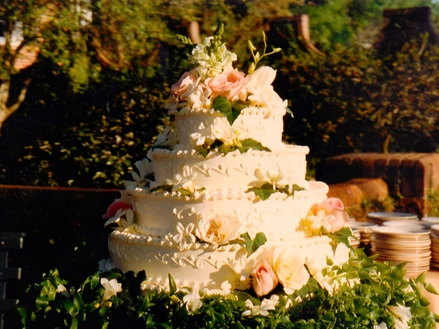 Tiered wedding cake with floral decorations.