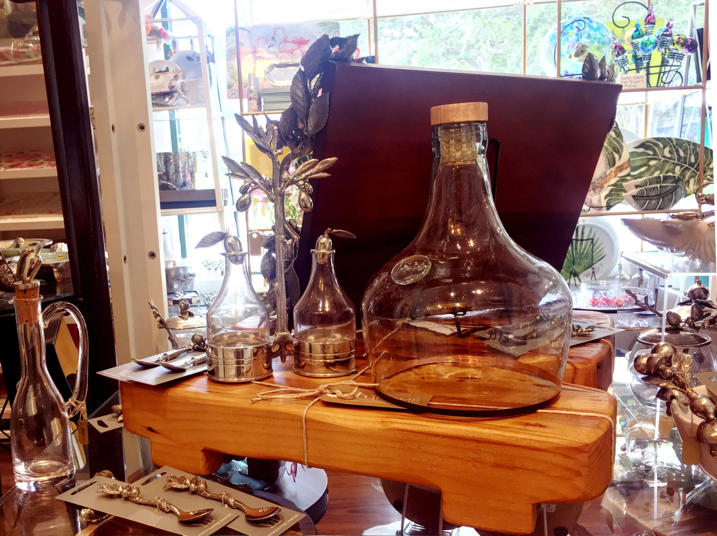 Glass bottles on wooden display in shop.