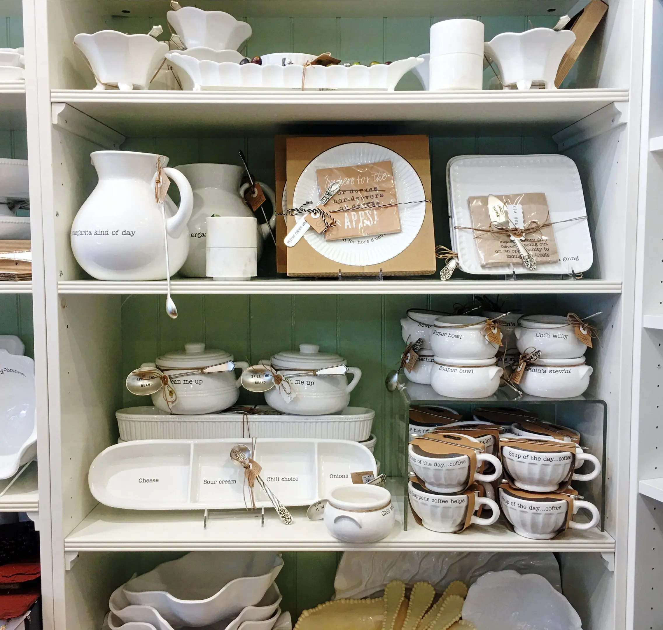 White kitchenware displayed on store shelves.