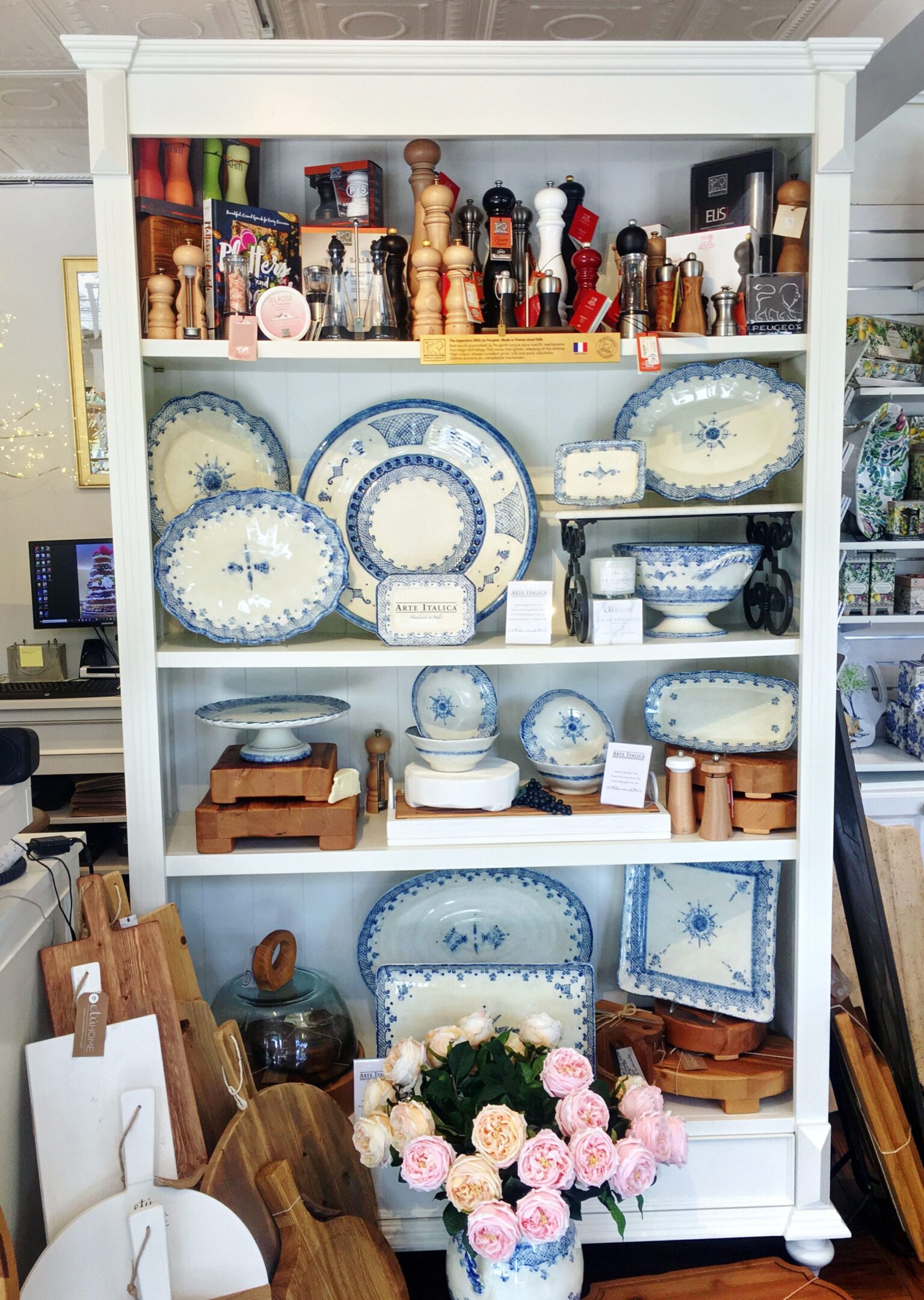 Kitchenware display with plates and pepper mills.