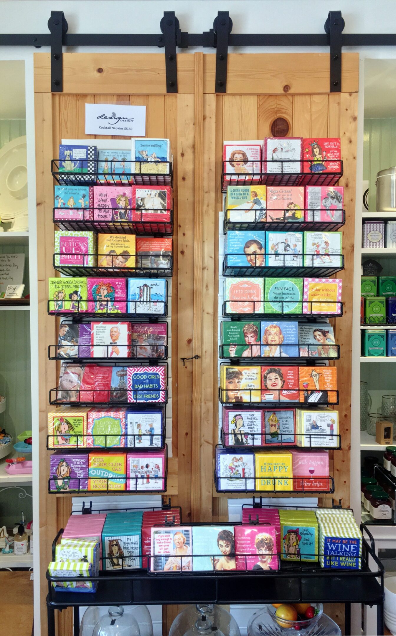 Greeting cards displayed on wooden wall rack.