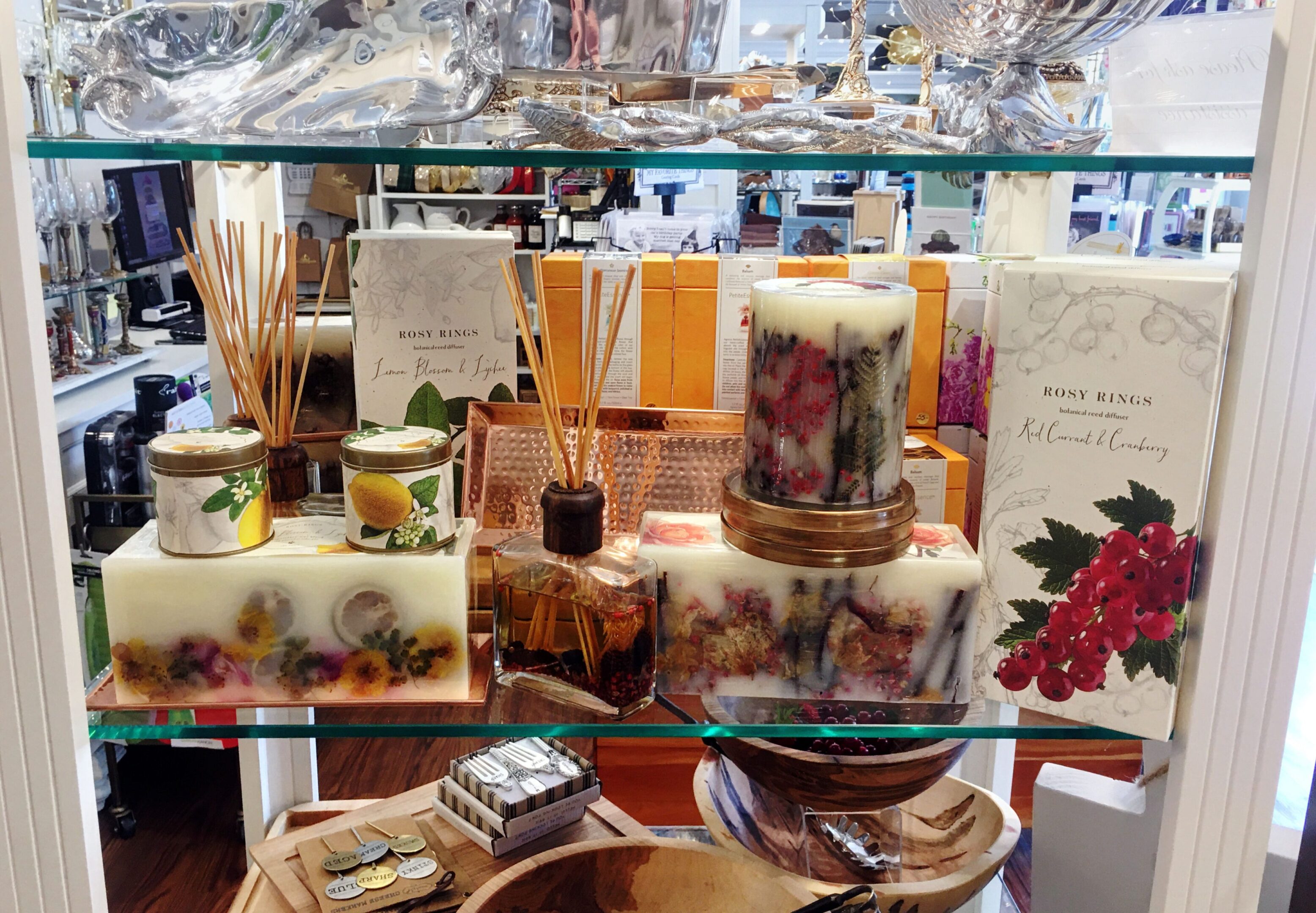 Decorative candles and reed diffusers on display.