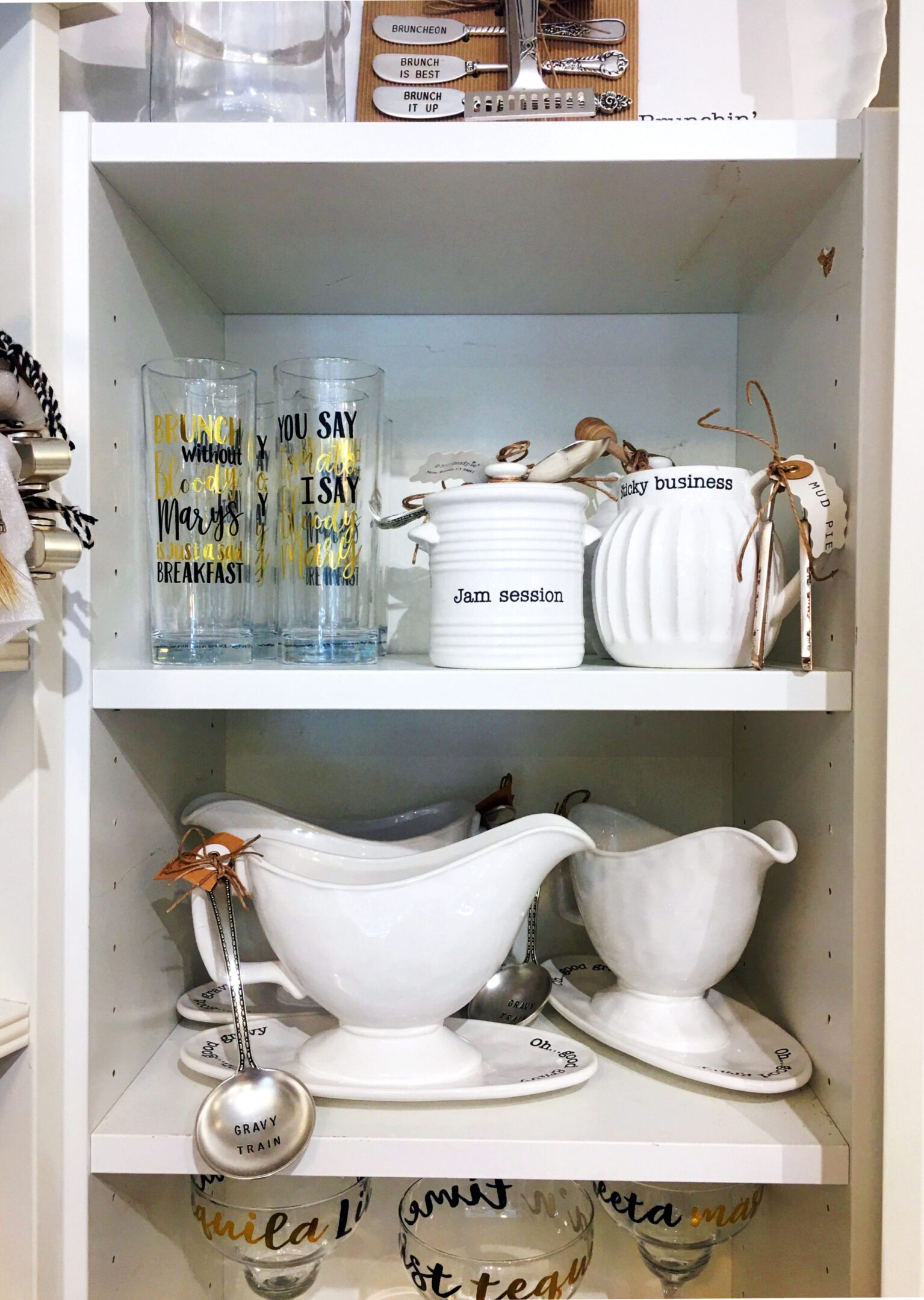 Kitchen items arranged on white shelves.